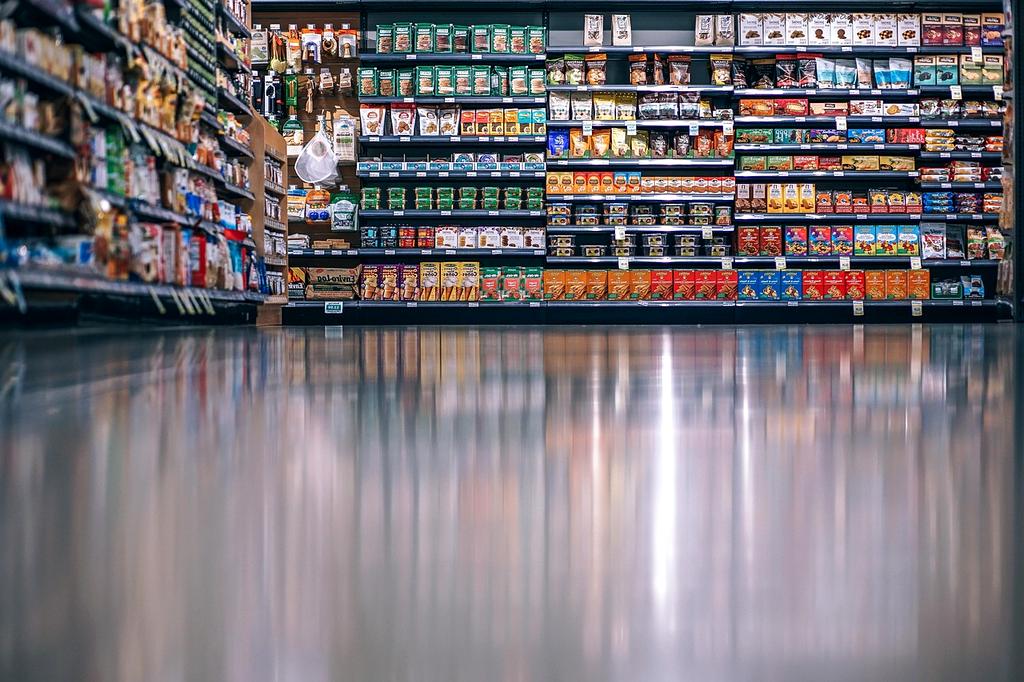 Grocery store aisles with clear signage and well-stocked shelves